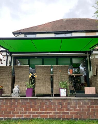 Green canvas awnings over patio