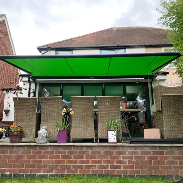 Green canvas awnings over patio