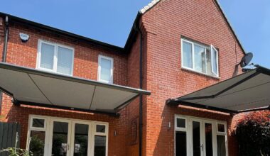 Modern house with 2 retractable awnings over patio