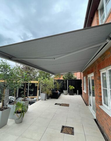 Grey retractable awning over patio