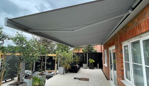 Grey retractable awning over patio - Cyra Group Ltd