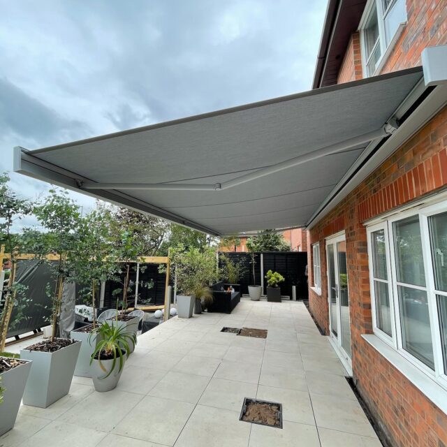 Grey retractable awning over patio