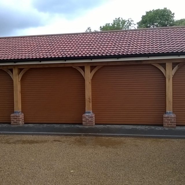 4 brown roller garage doors on external garage