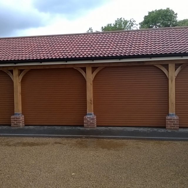 4 brown roller garage doors on external garage