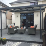 Black veranda in garden with outdoor seating underneath