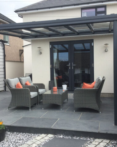 Black veranda in garden with outdoor seating underneath