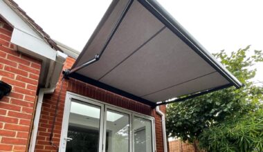 Grey awning above a wooden bench.