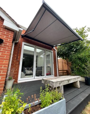 Grey awning above a wooden bench.